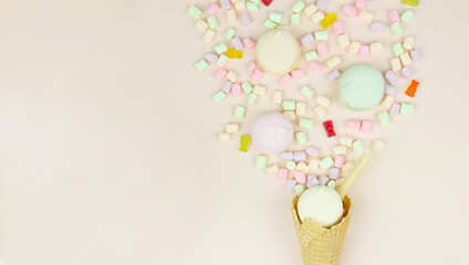 Waffle horn with colored marshmallow looks like macaroons on a pink pastel background. Holiday and celebration concept
