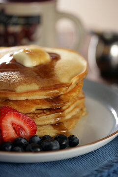 Stack of Pancakes with Syrup and Butter and Fruits