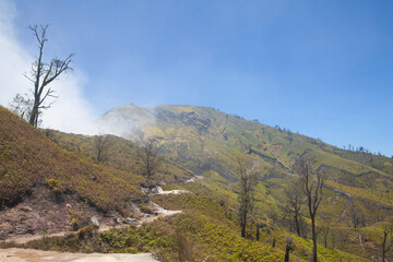 The mountain trail is shrouded in volcanic gas. Mountains on the island of Java, Ijen volcano.