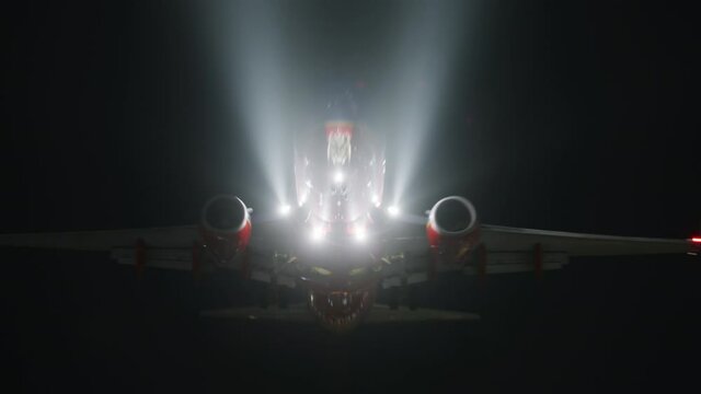 Astonishing scene of the passenger plane flying with additional lighting at night. Motion wallpaper for the aviation business concept. High quality 4k footage