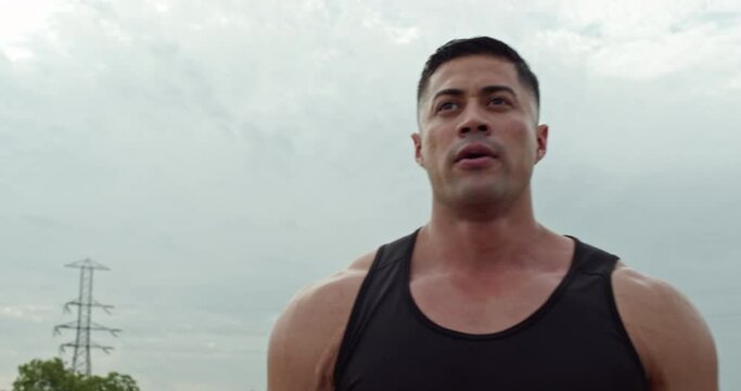Man take deep breaths after workout session