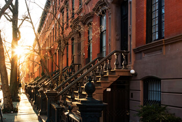 Block of historic brownstone buildings on Charles Street in the West Village neighborhood of New York City