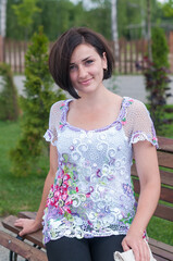 Fototapeta premium Close up fashionable image of charming brunette in knitted blouse smiling sincerely
