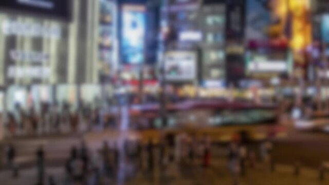 Blurred defocused Timelaps walking crowd people crossing street Taipei City. Pedestrians walk across road on busy streets. Timelapsed crowds asian walkers crossroad in crowded