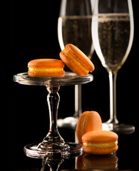 macaroons on the background of glasses with sparkling wine