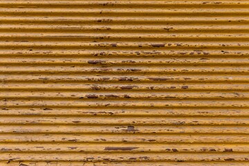 Old, yellow painted, rusted metal plate background. rustic top view background