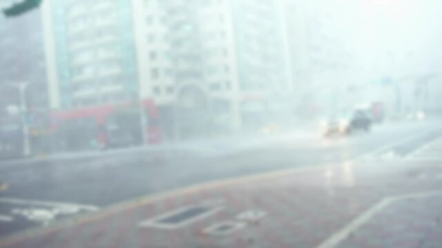 Blurred defocused Extreme Wind And Rain During A Super Typhoon Megi. A Street Taipei city with the strong hurricane winds. Car Traffic in asian road. 