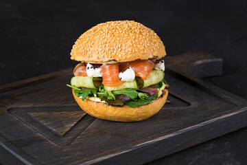 fresh burger with veal cutlet on a wooden background.