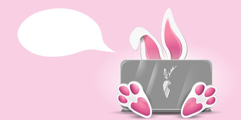 Cute rabbit behind laptop
