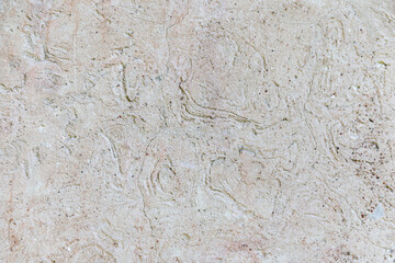 The texture of a gray-pink cement wall with corrugated stains. Gray-pink cement plaster.