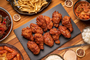 Korean fried chicken with spicy sauce  traditional Korean food, Fried chicken with rice and Kimchi pickle on wooden table.