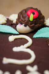 Marzipan hedgehog figure on a cake.