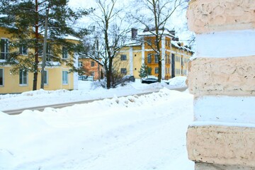 town in the snow, old small stone colorful houses on the city street in snow at winter