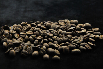 coffee beans in the dark on a dark background. blur