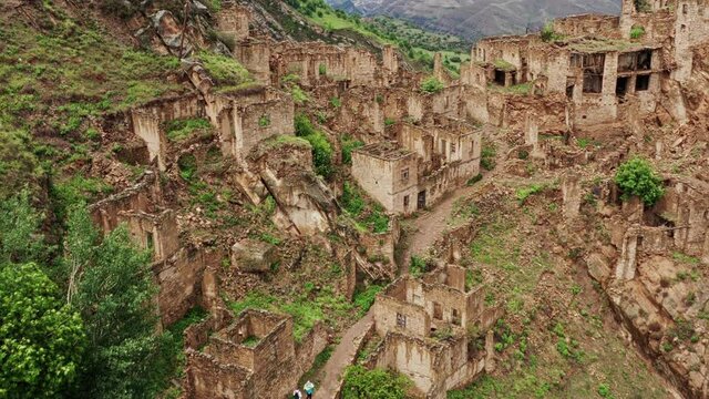 Abandoned in the mountains, the village of Gamsutl. Ghost town, ruins of an old settlement, Impregnable mountain fortress in the Dagestan mountains. Aerial view of an ancient village. 10 bit Video.