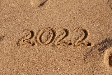Inscription 2022 on the sand on the shores of the Red Sea.