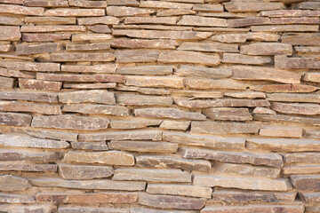 A wall of carved stones as a background.