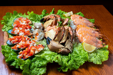 seafood platter with crab, shrimp, mussels and lettuce leaves underneath