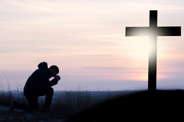 Prayer. Repentance.. Crucifixion against the sky. Clasped hands in prayer. Crucifixion at Calvary....
