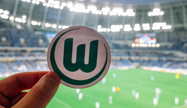 September 12, 2021, Wolfsburg. The emblem of the football club VfL Wolfsburg on the background of a modern stadium.