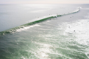 Aerial of Surfers on long hurricane waves in Rhode Island