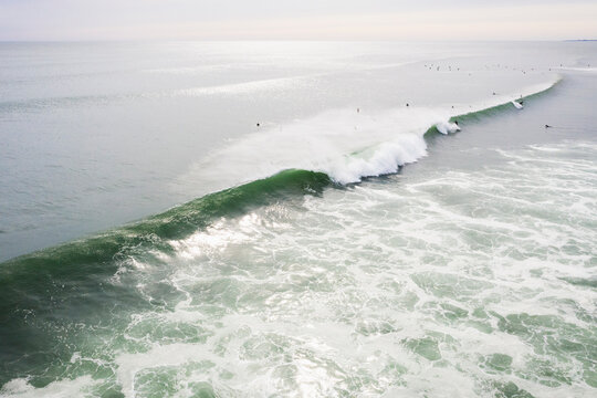 Aerial of Surfers on long hurricane waves in Rhode Island