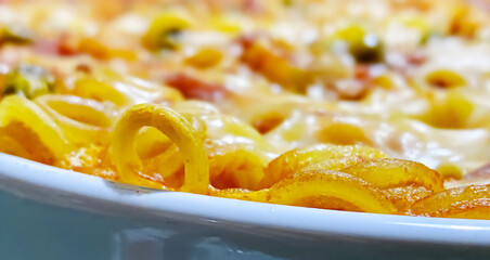 Close up of baked anelletti. Anelletti al forno (baked anelletti) are a type of baked pasta typical of Palermo and its province but also widespread in the rest of Sicily - obrazy, fototapety, plakaty