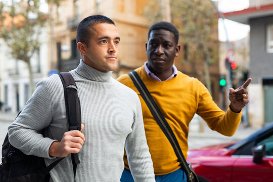 African-american and European men going through town streets.