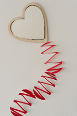 wooden heart with paper zig zag tail