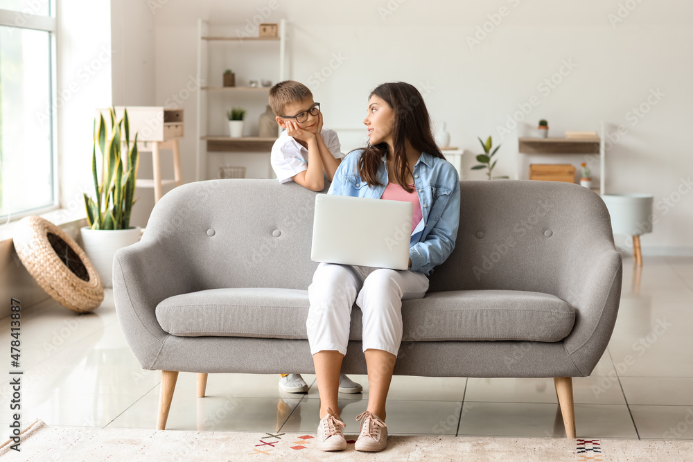 Wall mural teenage girl with laptop and her little brother at home