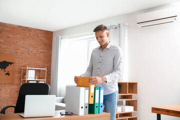 Young man working with documents in office