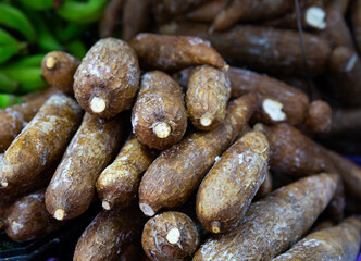 Close-up photo of yuca tubers disposed on market shelf.