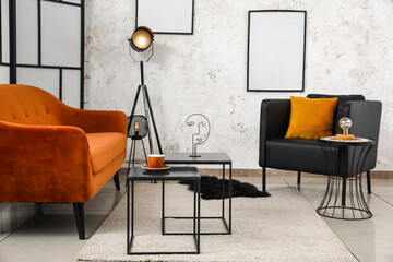 Interior of stylish living room with red sofa, armchair and coffee tables