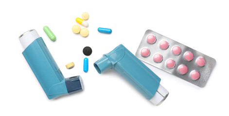 Asthma inhalers and tablets on white background