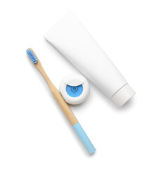 Blue bamboo tooth brush with paste and floss on white background