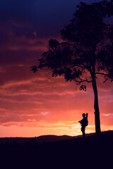 silhouette of a person on the top of a mountain