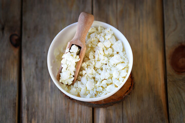 Fresh crumbly homemade cottage cheese in a bowl.