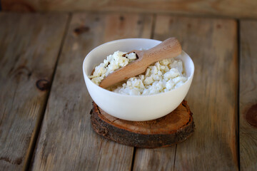 Fresh crumbly homemade cottage cheese in a bowl.