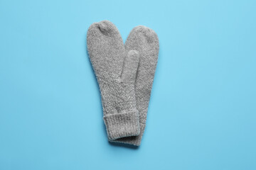 Warm mittens on color background