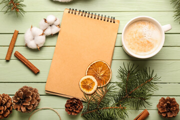 Obraz na płótnie Canvas Composition with notebook, cup of cacao and natural decor on color wooden background. Hello winter