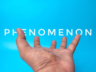 Opening hand with word PHENOMENON on a blue background.