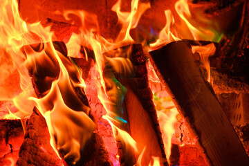flame. Fire and flames Sparks and flames close-up. Fireplace with logs and colorful flames.Multicolored flame.Firewood burning in bonfire.