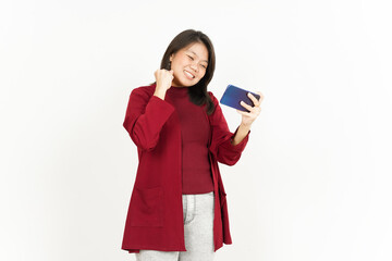 Naklejka premium Playing Mobile Game on Smartphone of Beautiful Asian Woman Wearing Red Shirt Isolated On White