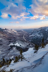 Classic winter landscape. The snowy valley and its sinuous road seen from Dome mountain at dusk, Quebec, Canada