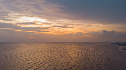 Aerial drone shot of seascape against the sky during golden hour at Sekinchan, Selangor, Malaysia.