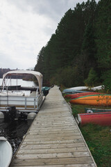 Boat dock by the lake with canoes on the lake bank