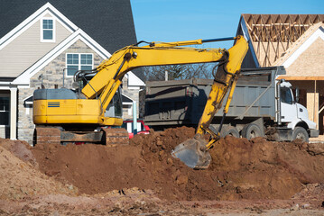 Excavator loads gravel into a truck