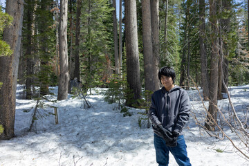 young man playing in the snow