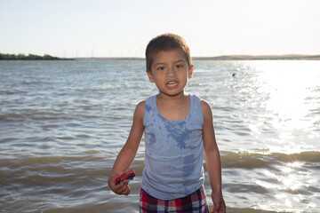 Fototapeta na wymiar boy playing in the lake