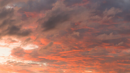 Naklejka na ściany i meble sunset with clouds in the orange sky